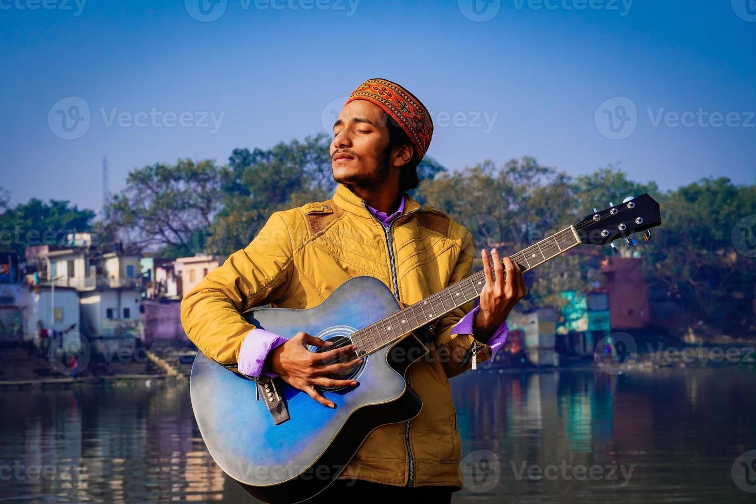 Man playing guitar on the boat. photo