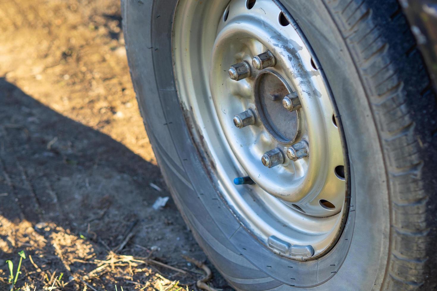 Low angle shot of a car wheel with sunlight photo