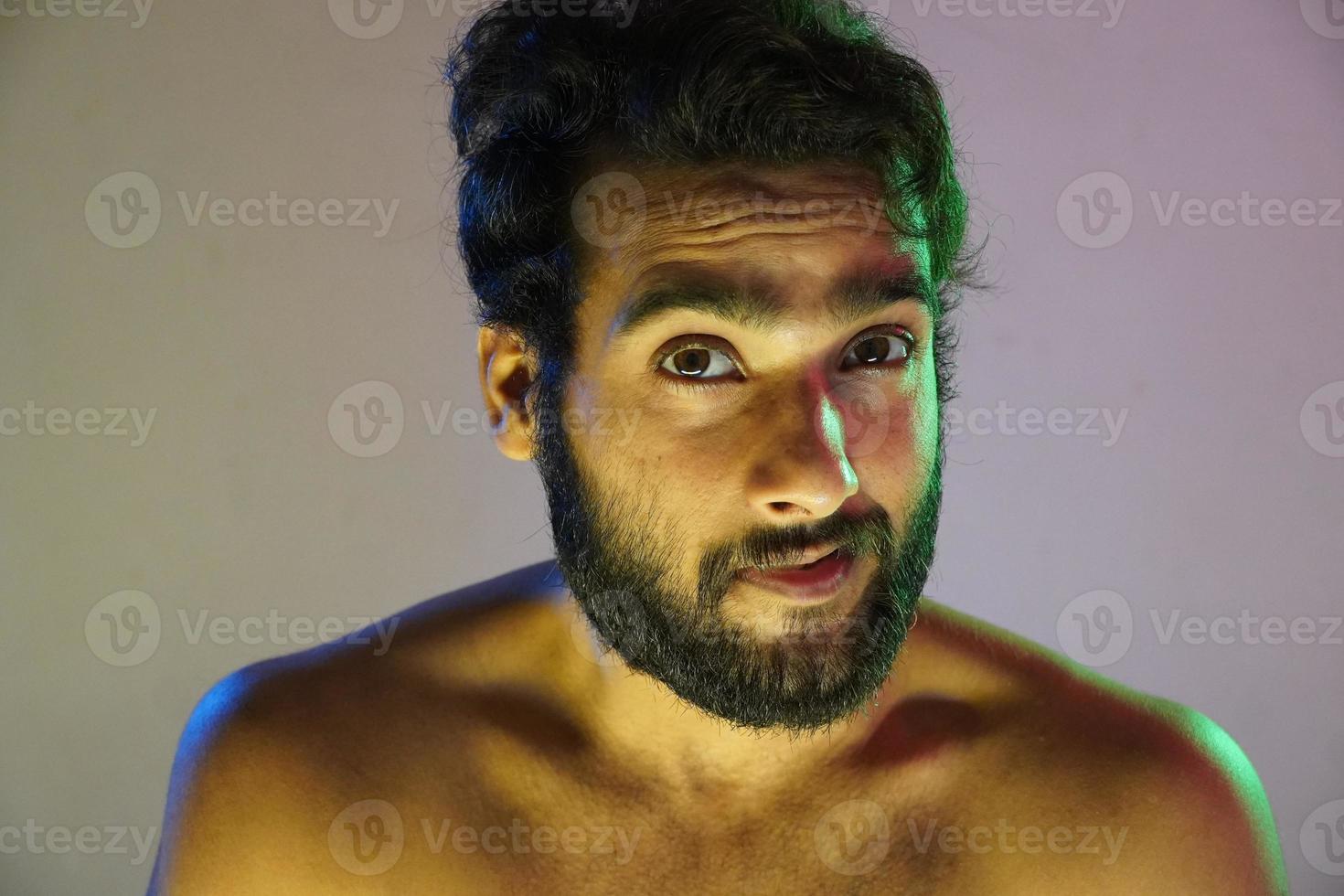 blue and green lightning on face Portrait of a man in studio photo