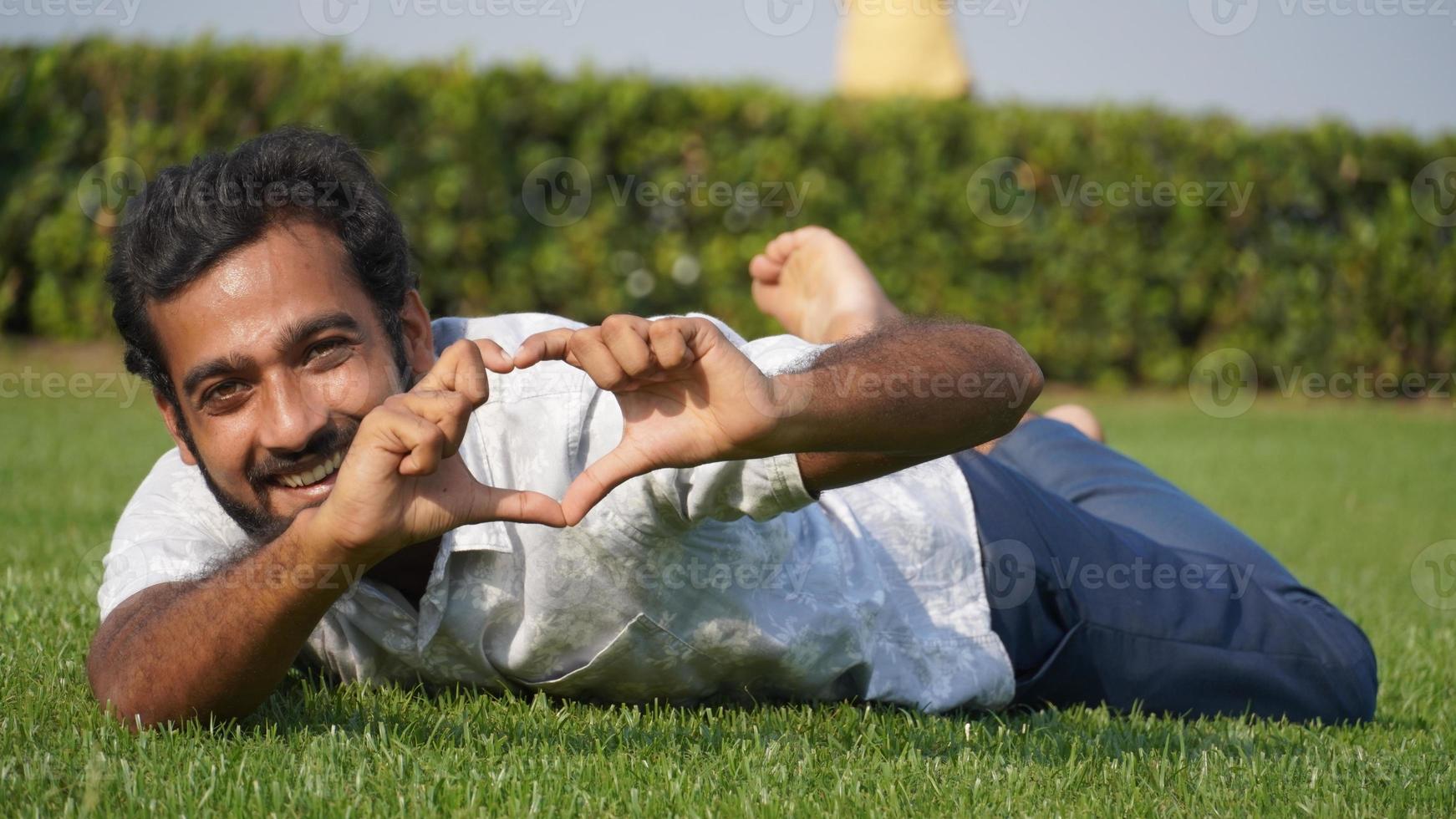 man in grass and smiling photo
