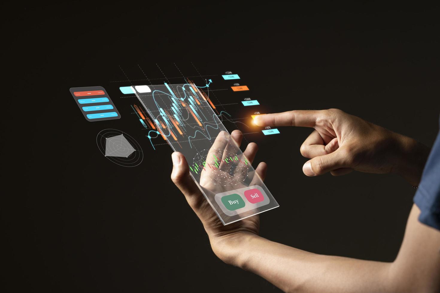 close up business man with  stock chart market hologram dark background photo