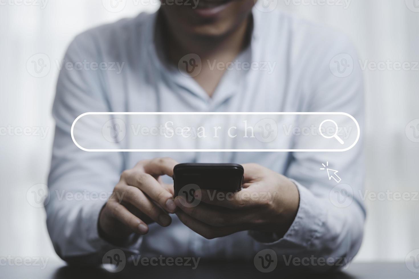 Hand using mobile phone  with search icon for Search Engine Optimisation or SEO concept to find information by internet connection. photo