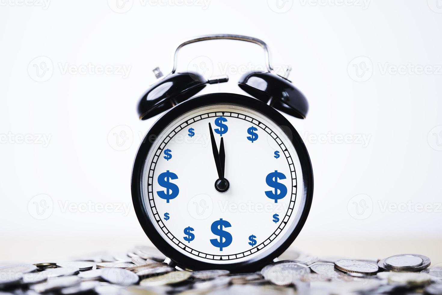 Dollar sign print screen inside alarm clock on heap of coins for time and money management concept. photo