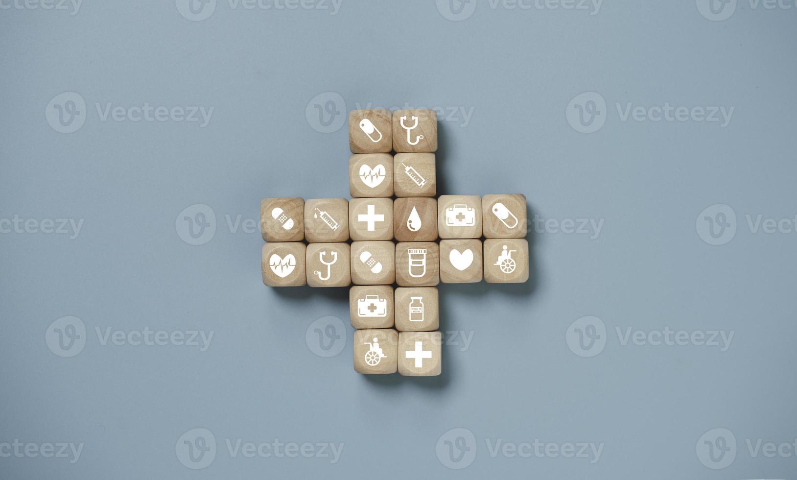 Wooden block cube which print screen health care and medical icons for healthy and wellness concept. photo