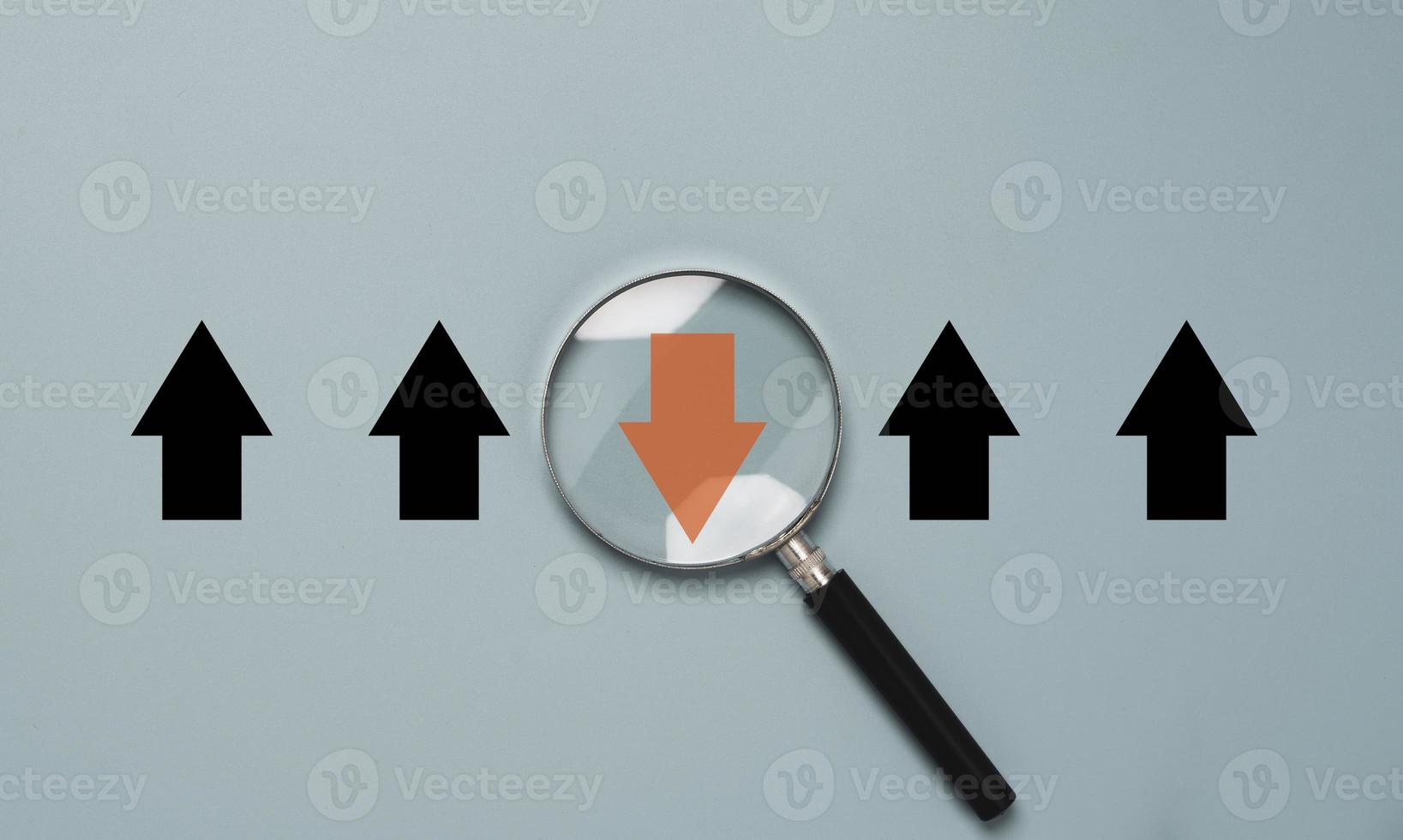 Red arrow inside of magnifier glass and different direction from white arrow for focus business disruption and technology transformation concept. photo