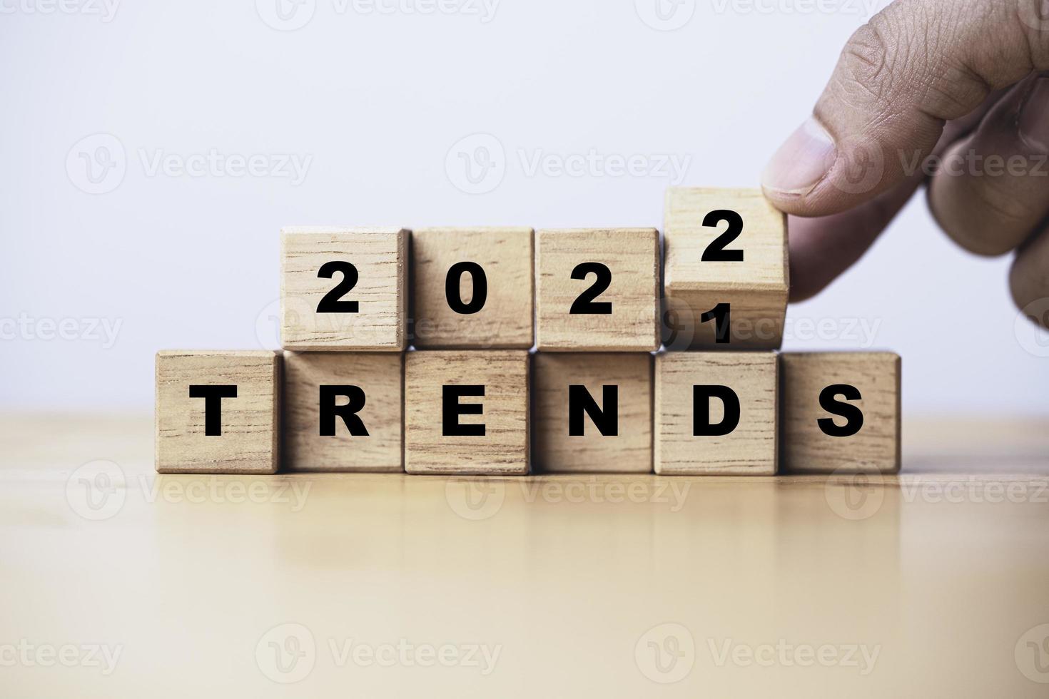 Hand flipping for change trend from 2021 to 2022 for new year business and fashion trend concept. photo