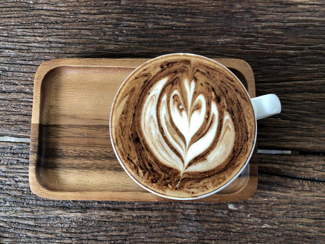 Hot latte art coffee cup on wooden table 6860201 Stock Photo at Vecteezy