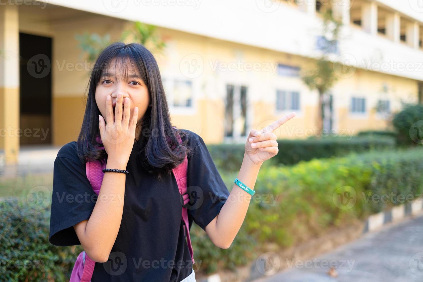 Student young girl hold pink book and backpack at school,back to school. photo