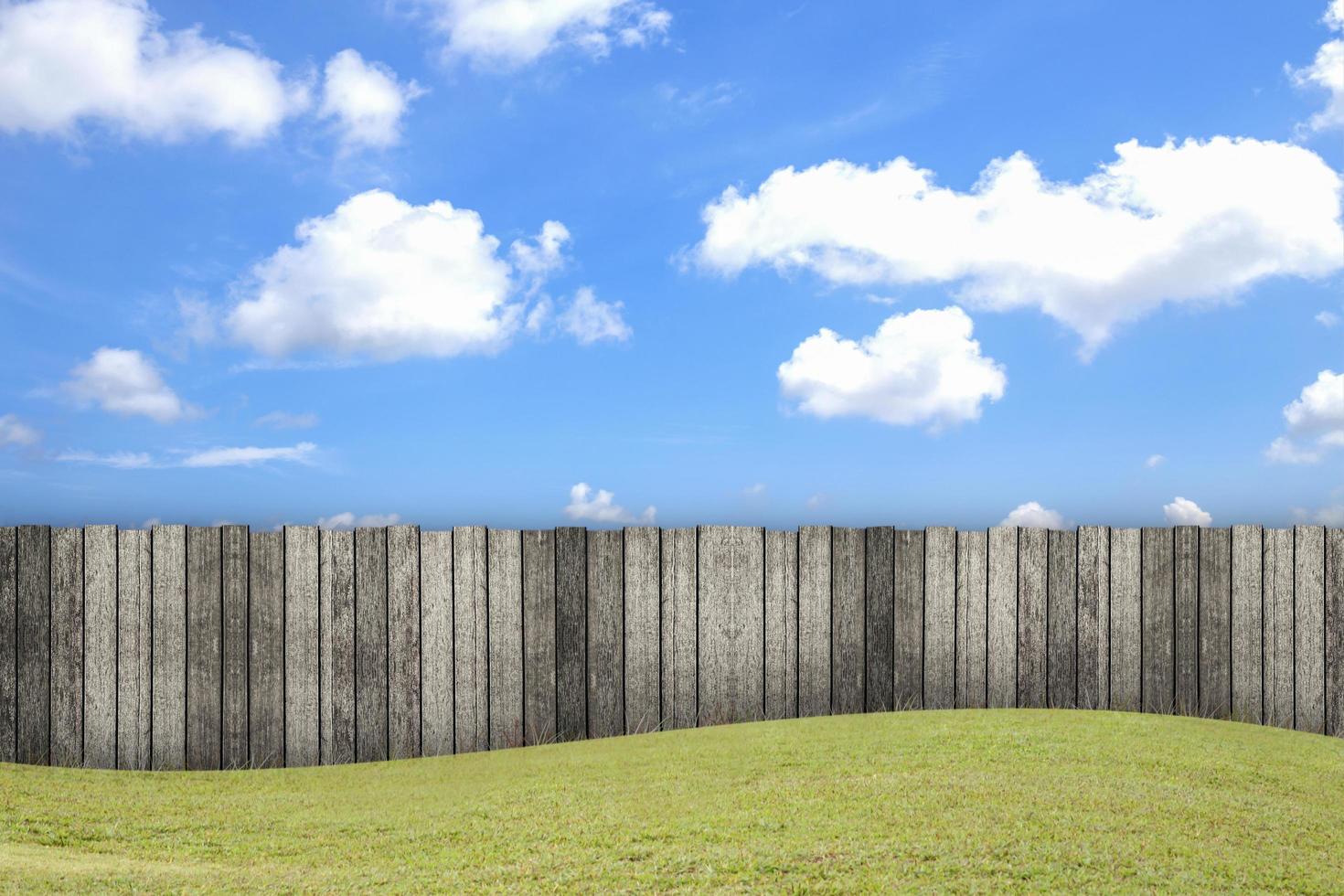 Empty wooden garden fence at backyard and blue sky background at a summer day photo