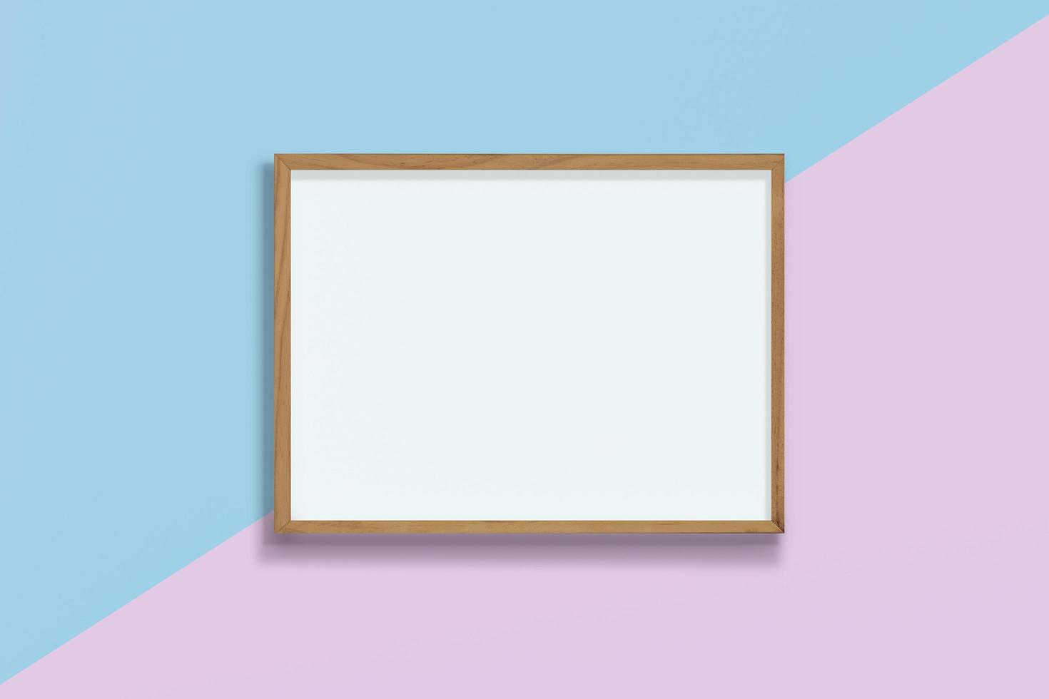 Horizontal empty wooden frame on pink and blue pastel background , blank frame mock up with copy space, photo