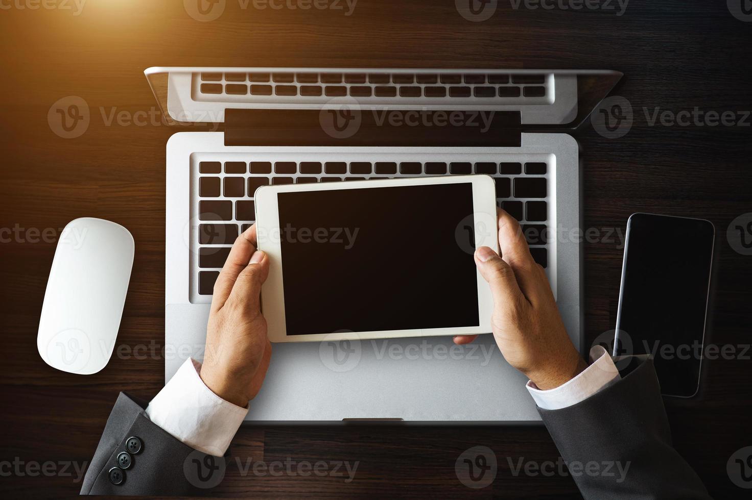 Top view business hand working with laptop computer, tablet and smart phone in office photo