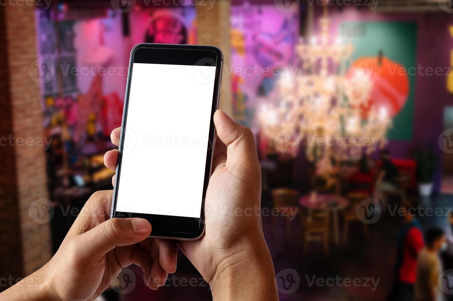 A woman hand holding smart phone device in the coffee shop or cafe photo