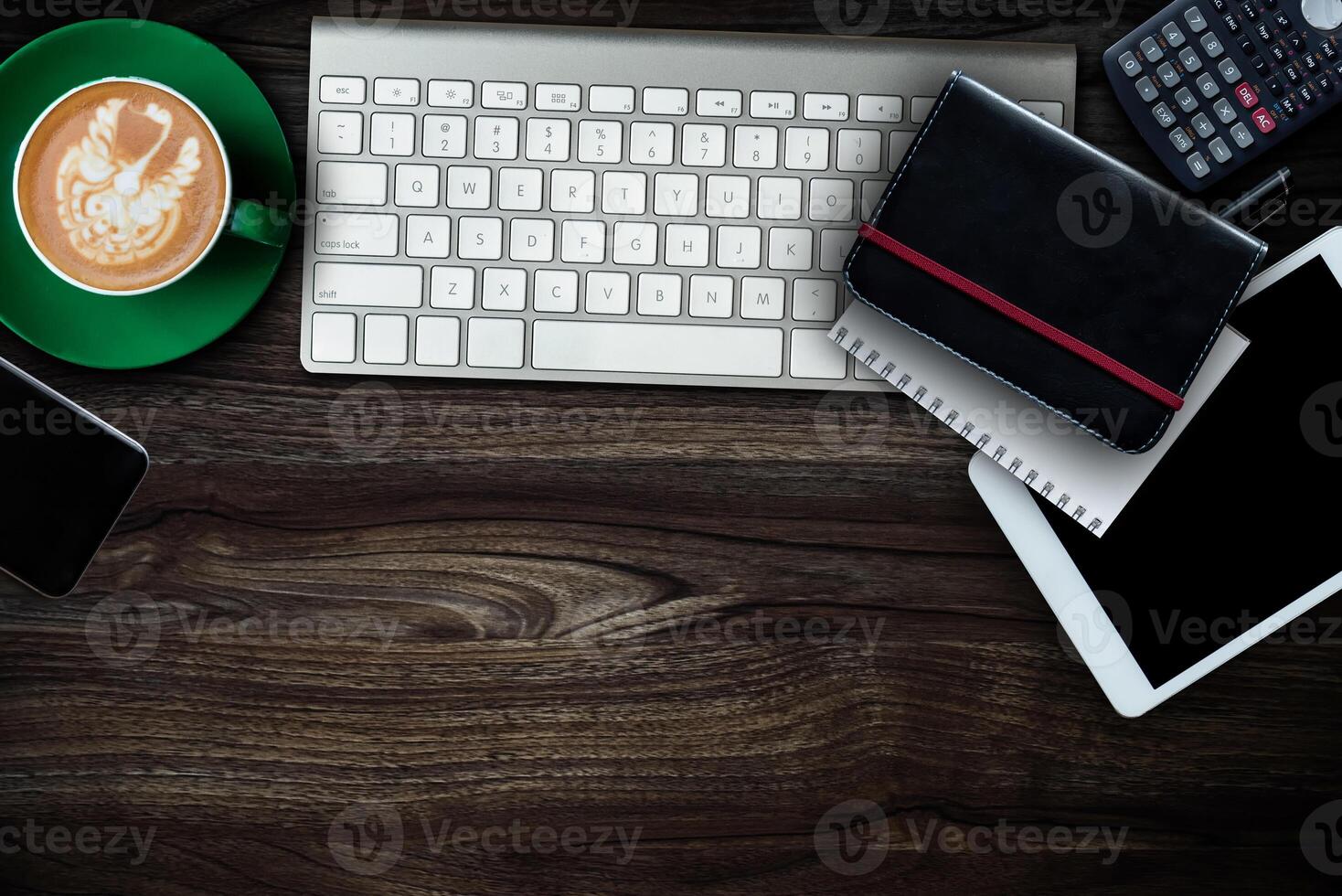 Top view of office desktop with various supplies and devices. Workplace concept photo