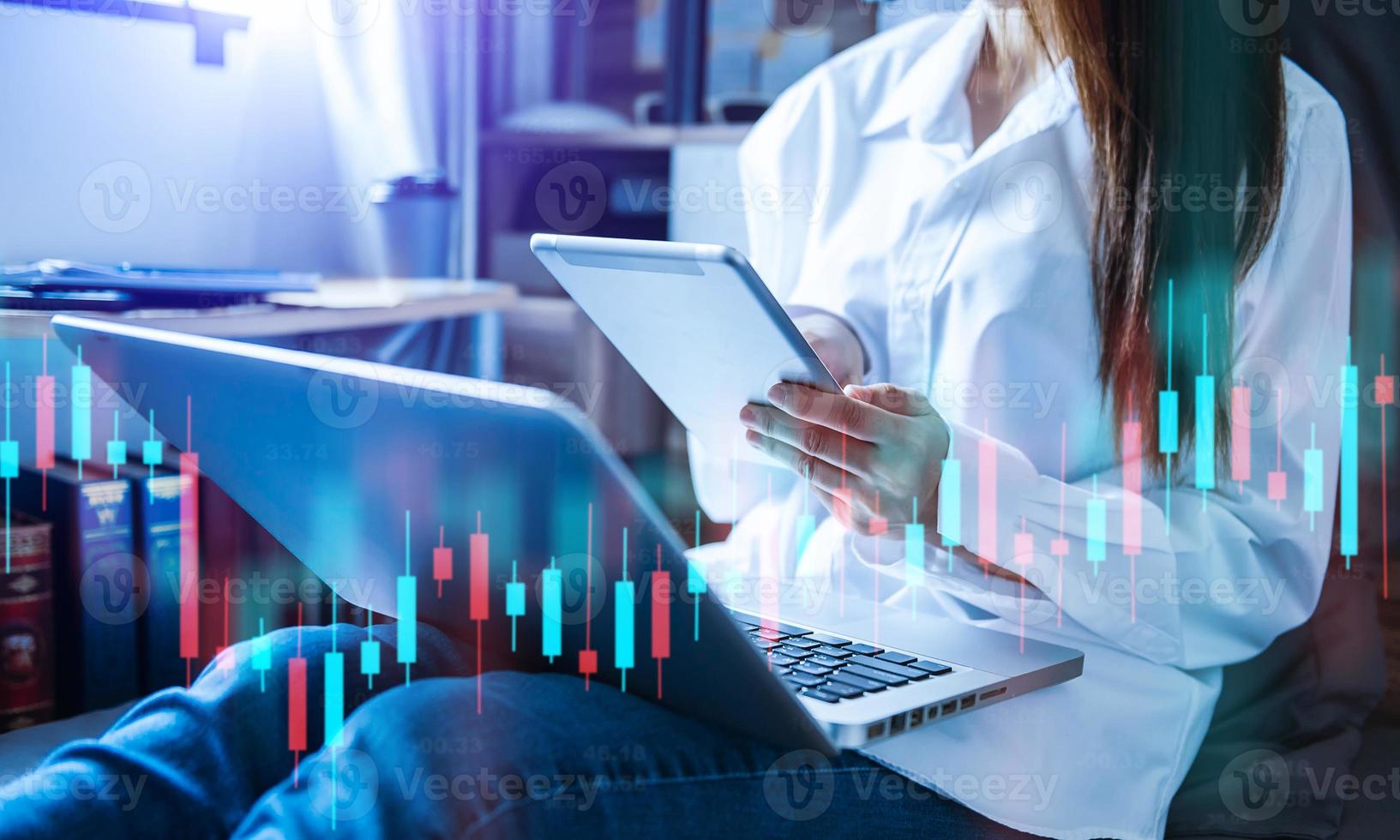 woman working at modern office.Technical price graph and indicator, red and Blue candlestick chart and stock trading tablet photo