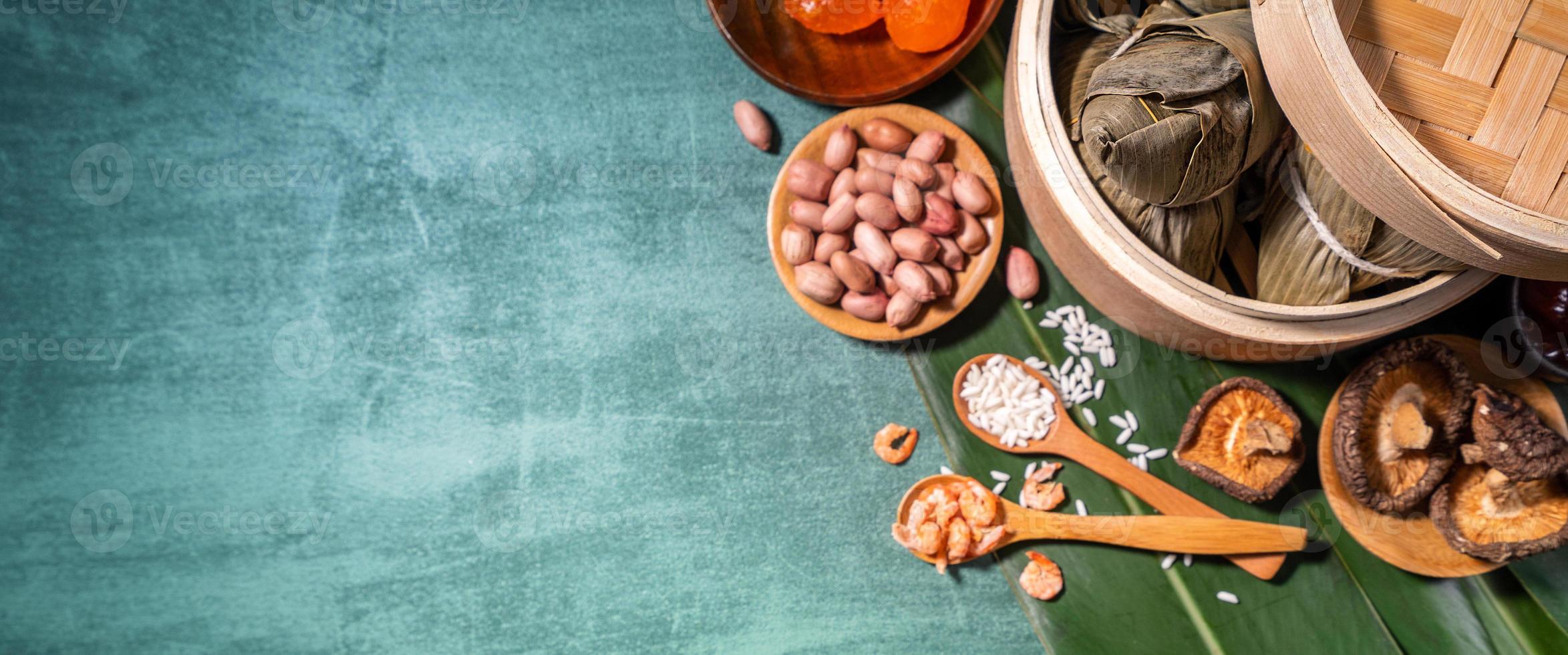 Zongzi, steamed rice dumplings on green table background, food in dragon boat festival duanwu concept, close up, copy space, top view, flat lay photo