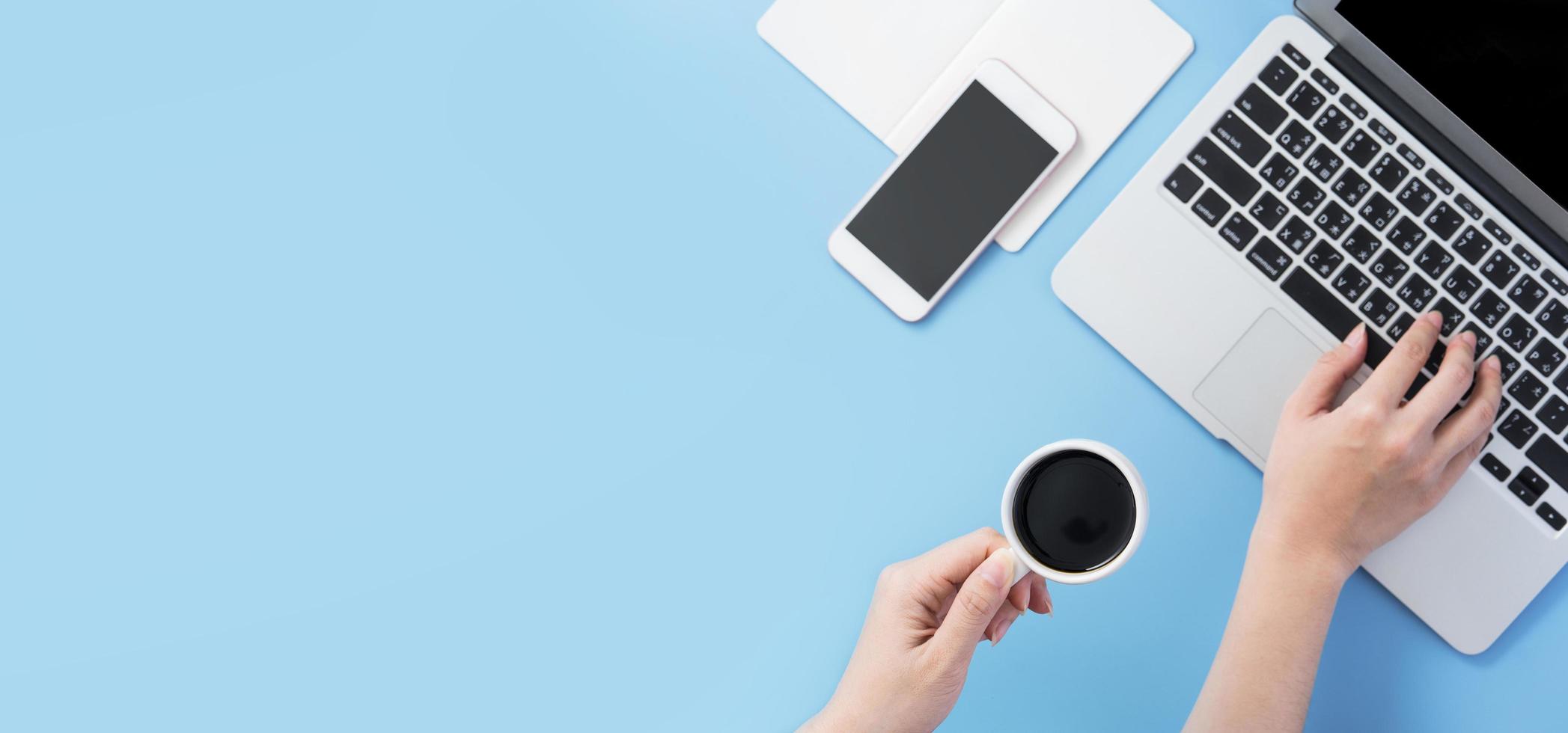 Freelancer blog writer woman drinking for relax on a clean light blue desk with coffee, work at home concept, copy space, flat lay, top view, mock up photo