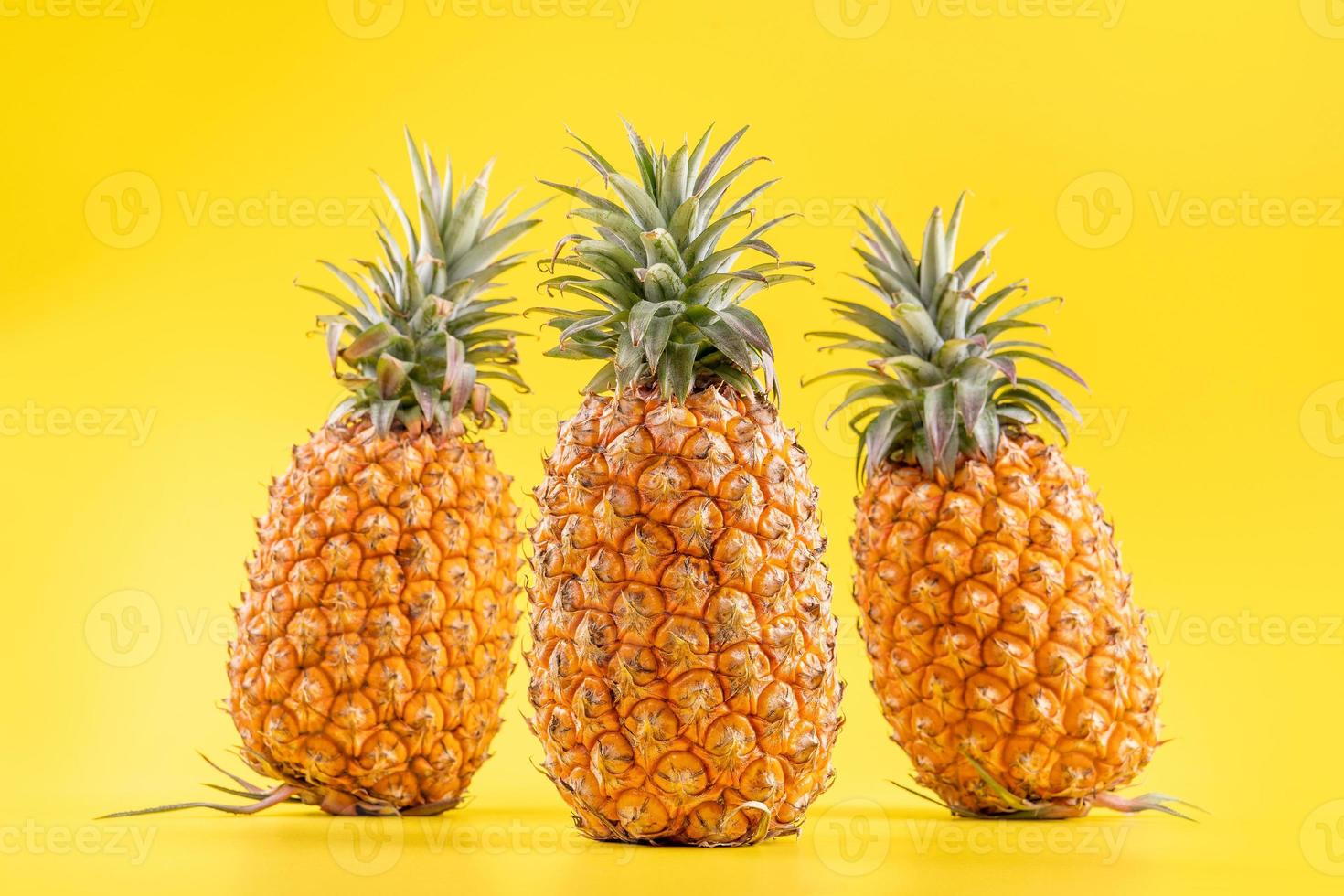 Beautiful fresh pineapple isolated on bright yellow background, summer seasonal fruit design idea pattern concept, copy space, close up photo