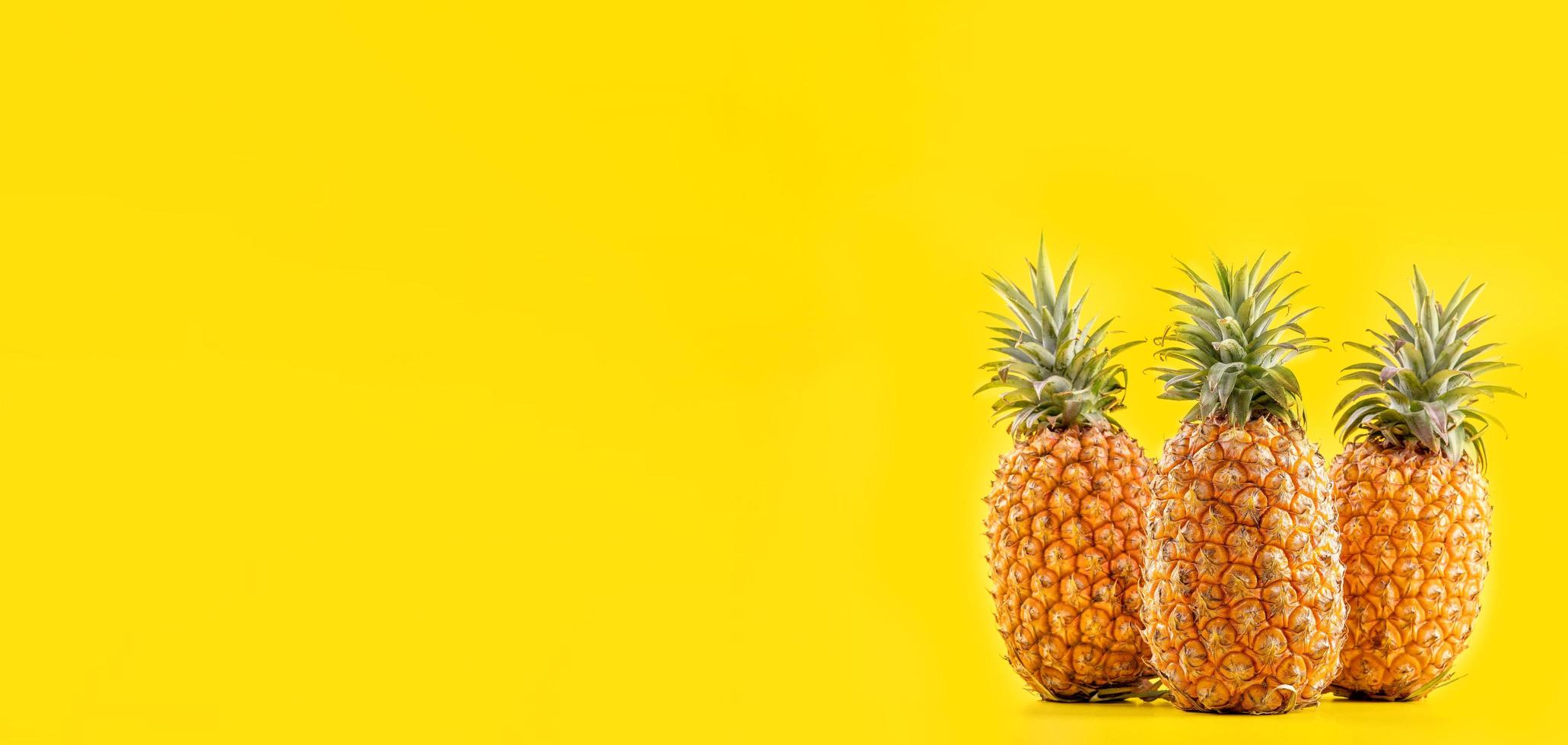 Beautiful fresh pineapple isolated on bright yellow background, summer seasonal fruit design idea pattern concept, copy space, close up photo