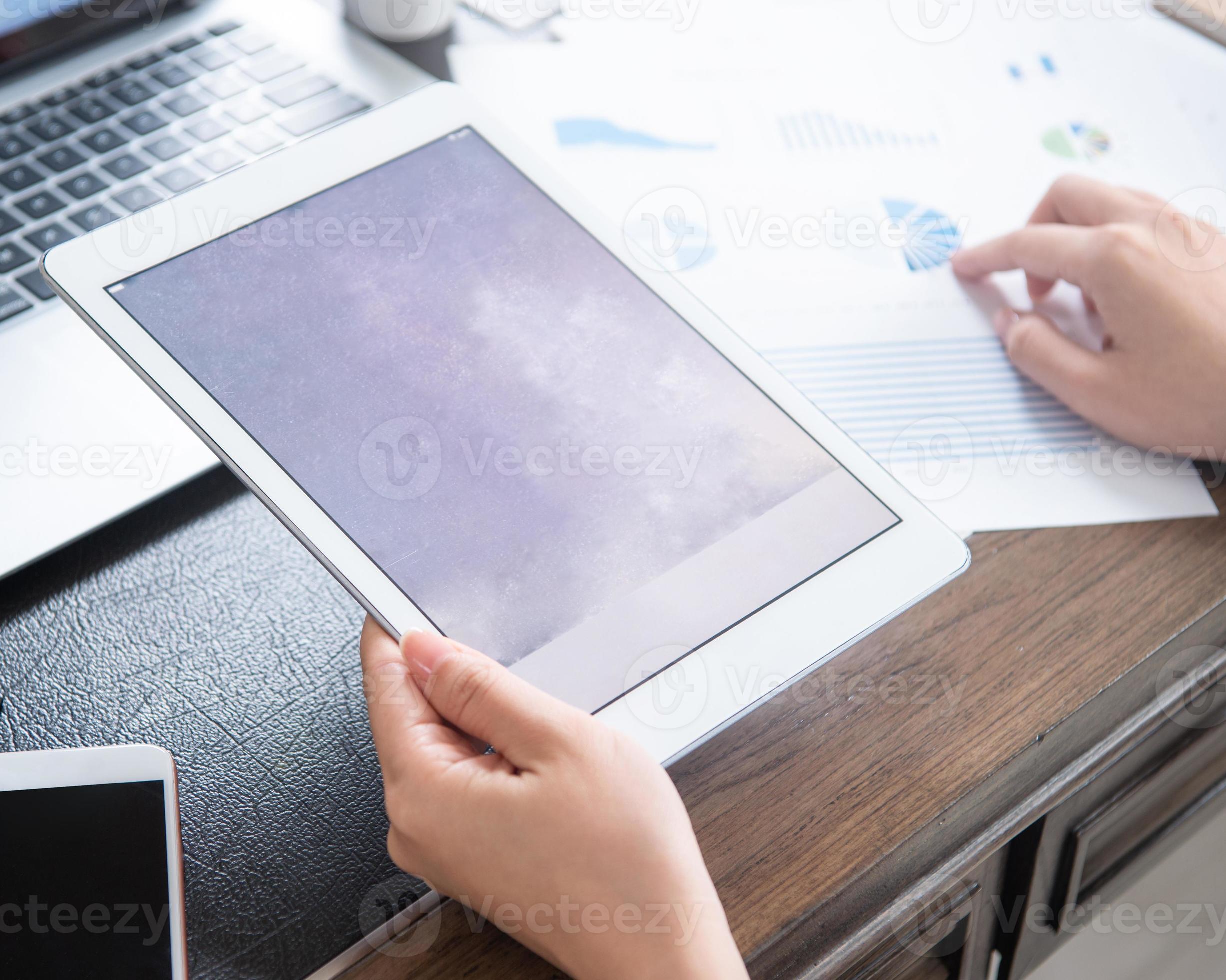 Business concept. Woman using tablet for project with digital device in office desk