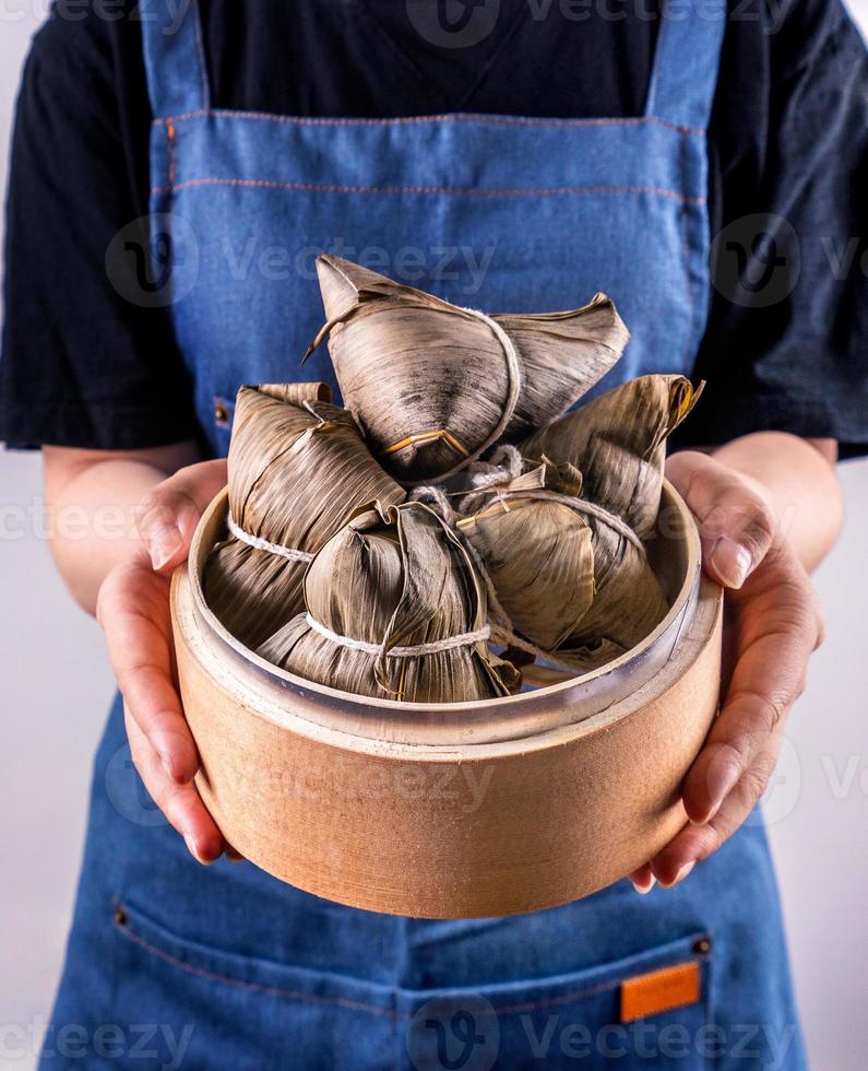 Zongzi, delicious steamed rice dumplings in steamer in black background for dragon boat duanwu festival, close up, copy space, top view, flat lay photo