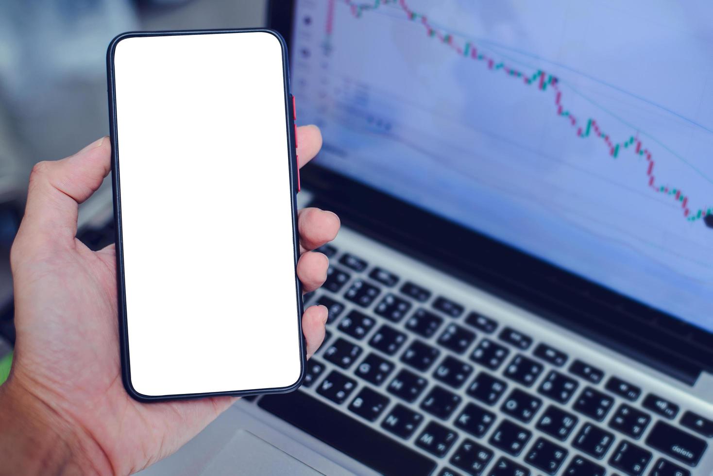 Hand holding a smartphone with a blank screen for entering text photo