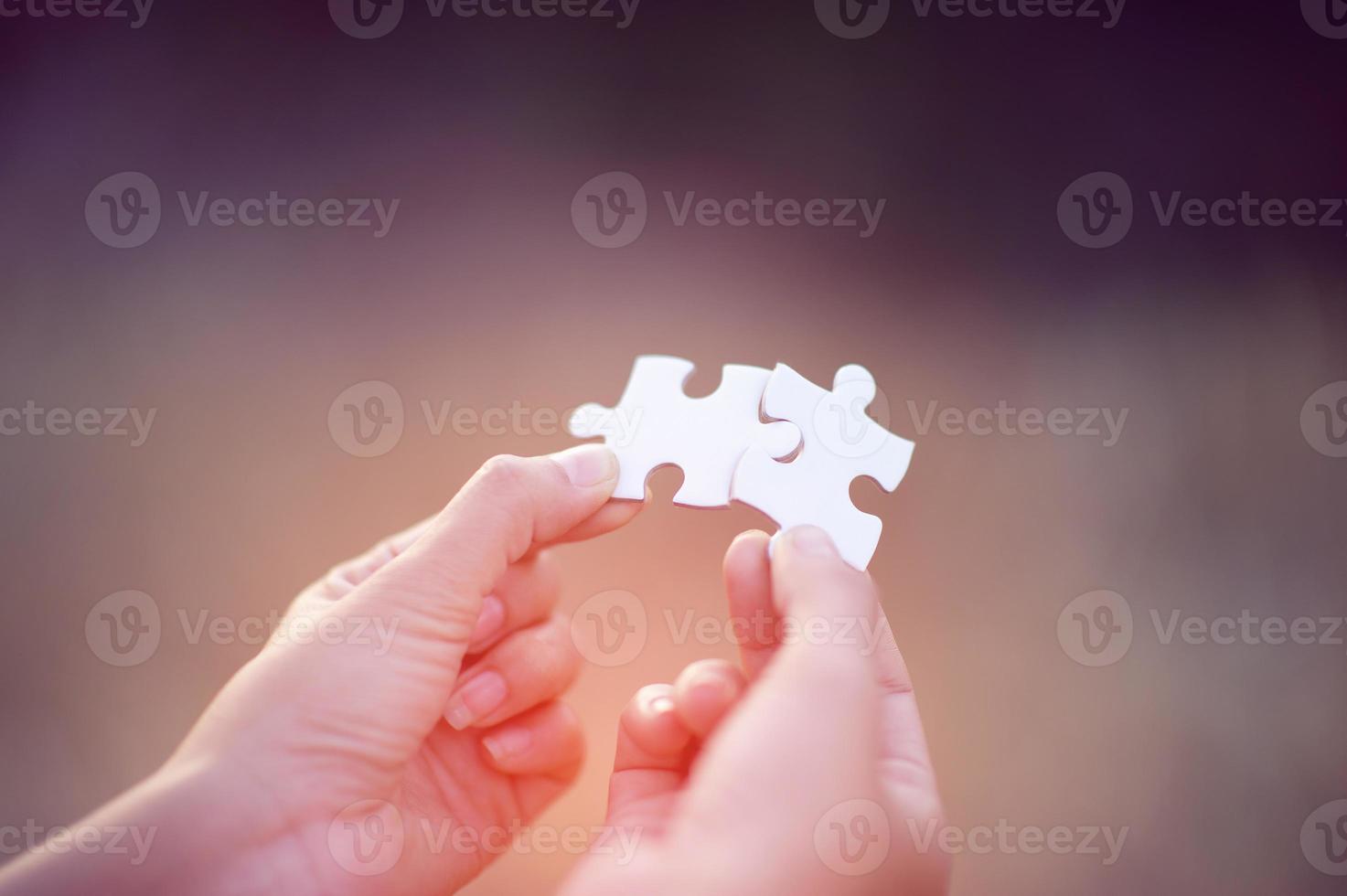 Hands and white jigsaw puzzles Close-up image and integration Business concept and unity photo