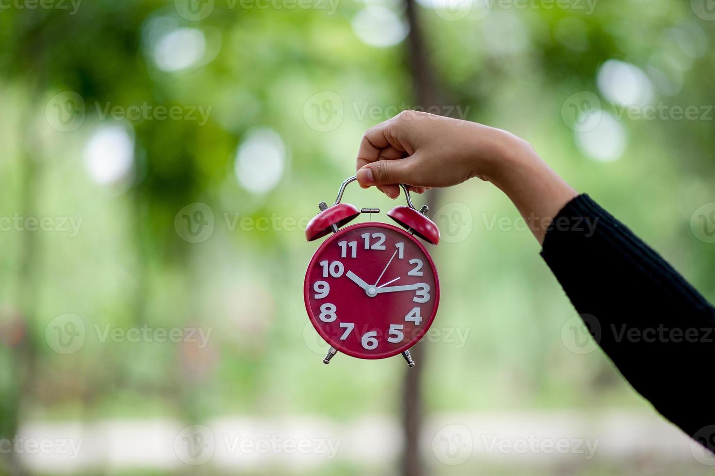 Red hand and alarm clock image Awakening concept With copy space photo