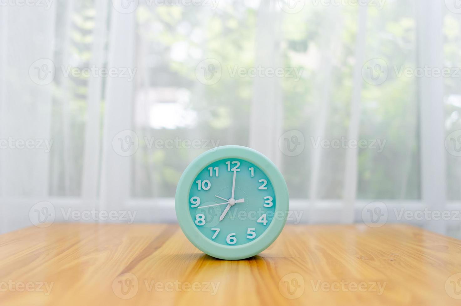 Light green alarm clock Placed on the table in the bedroom photo