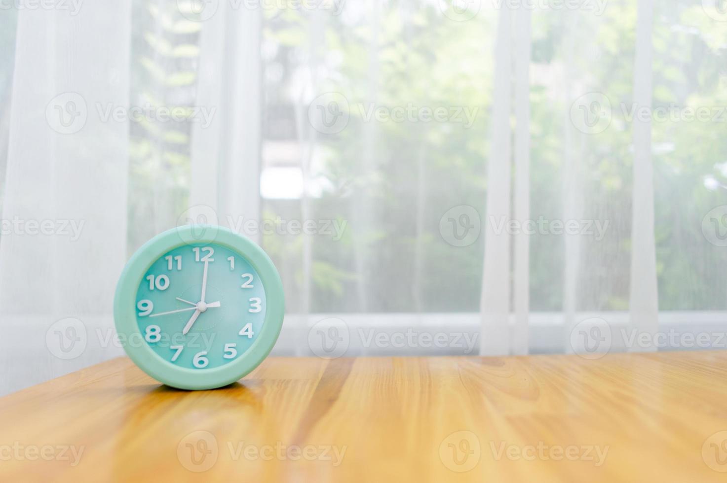 Light green alarm clock Placed on the table in the bedroom photo