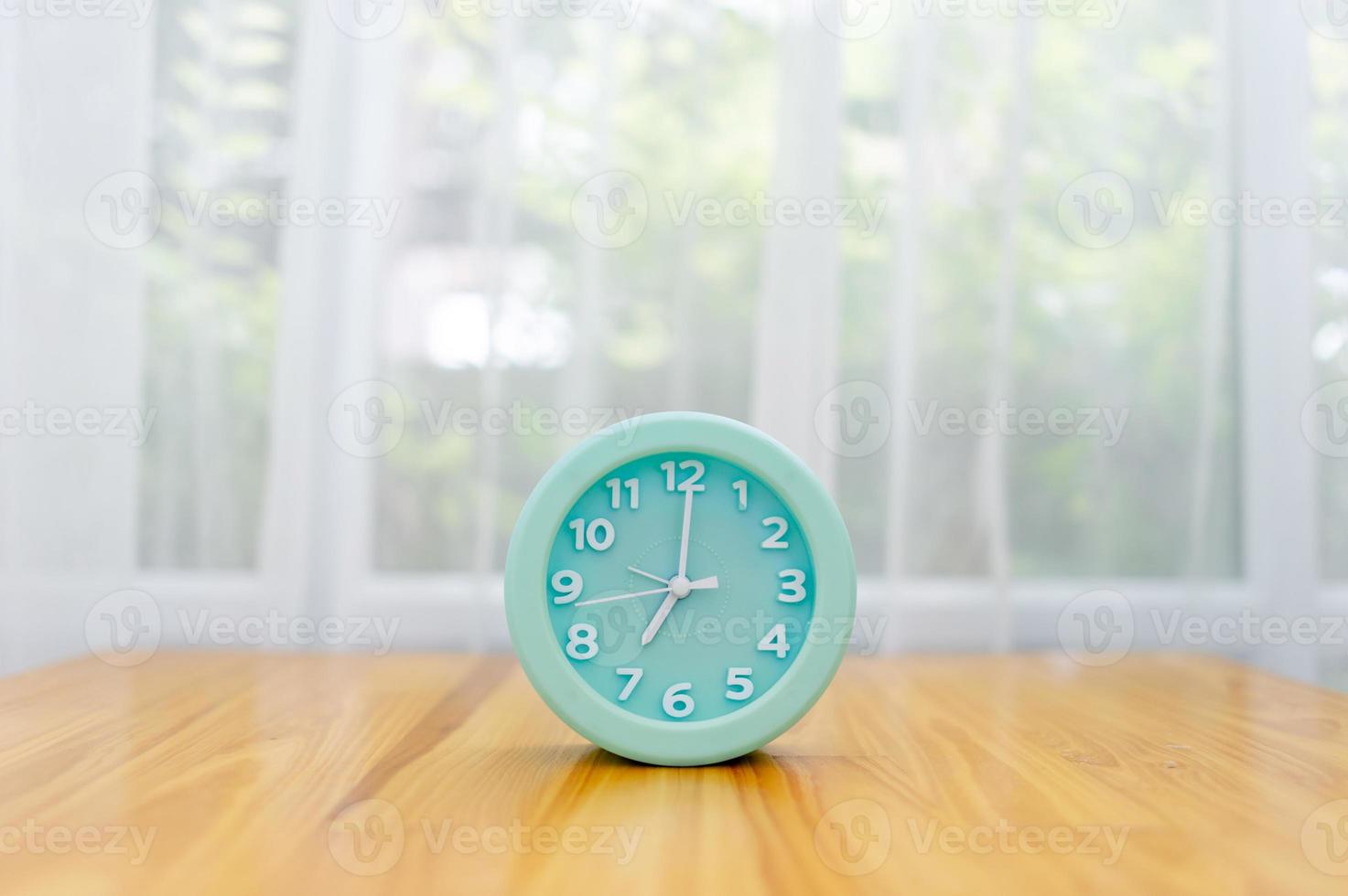 Light green alarm clock Placed on the table in the bedroom photo