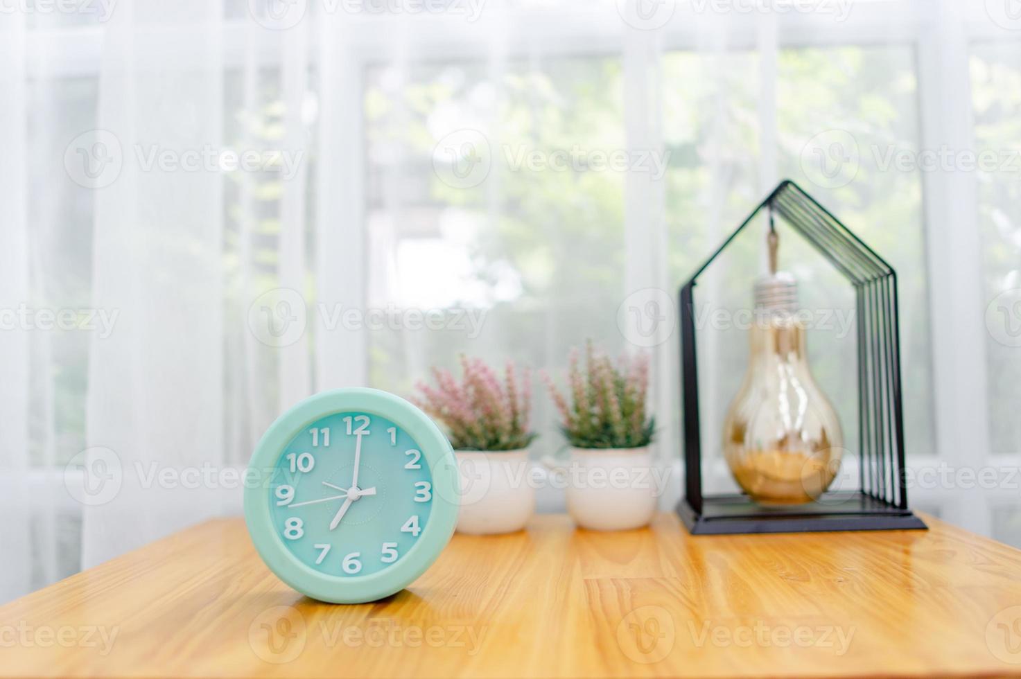 Light green alarm clock Placed on the table in the bedroom photo