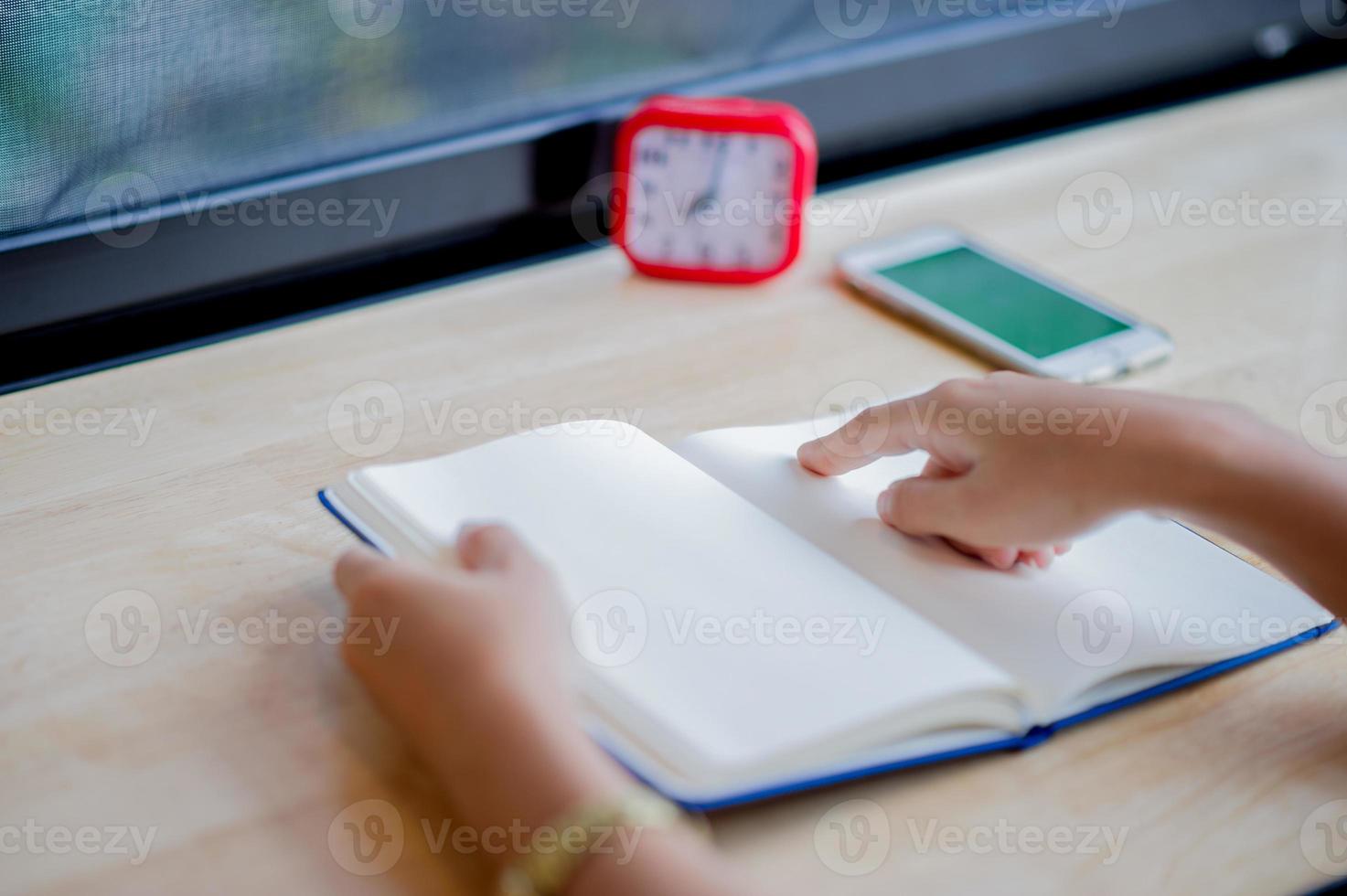 Hands and books that are laid bare with space In the morning room Book reading concept photo