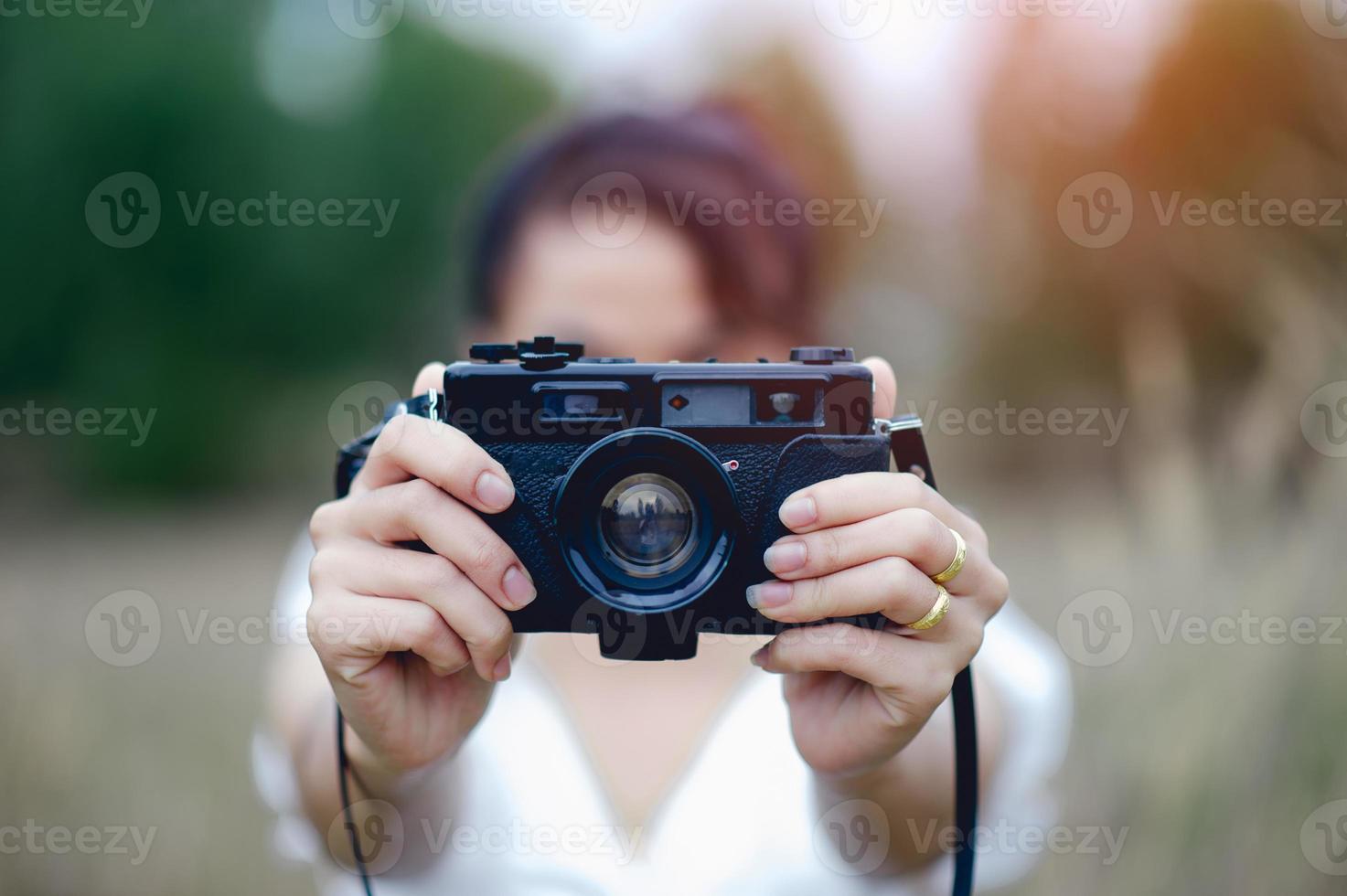 mano y cámara del fotógrafo sosteniendo y llevando la cámara para tomar fotografías foto