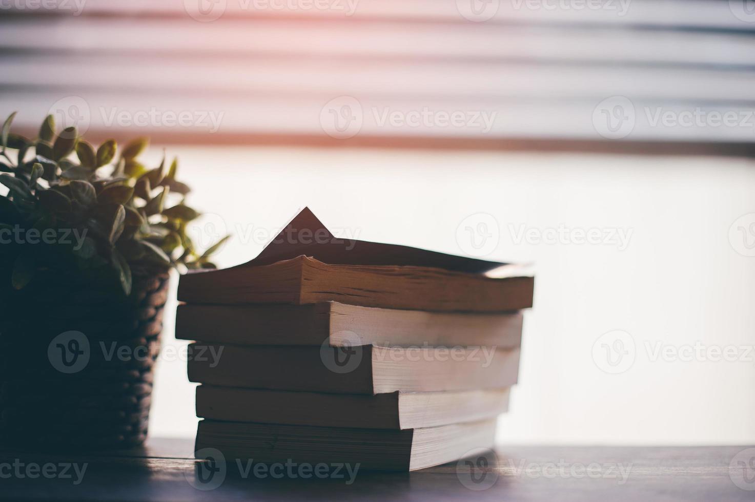 The book is overlaid on the top of the table. Reading concept photo