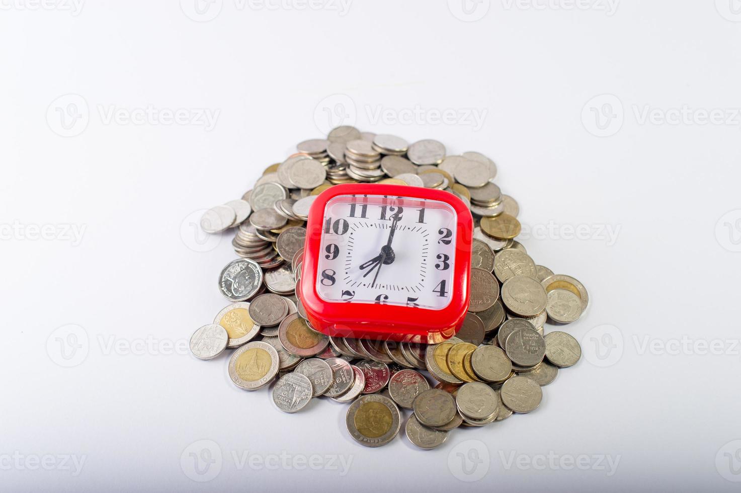 Money, baht coins on a white background and a red clock photo