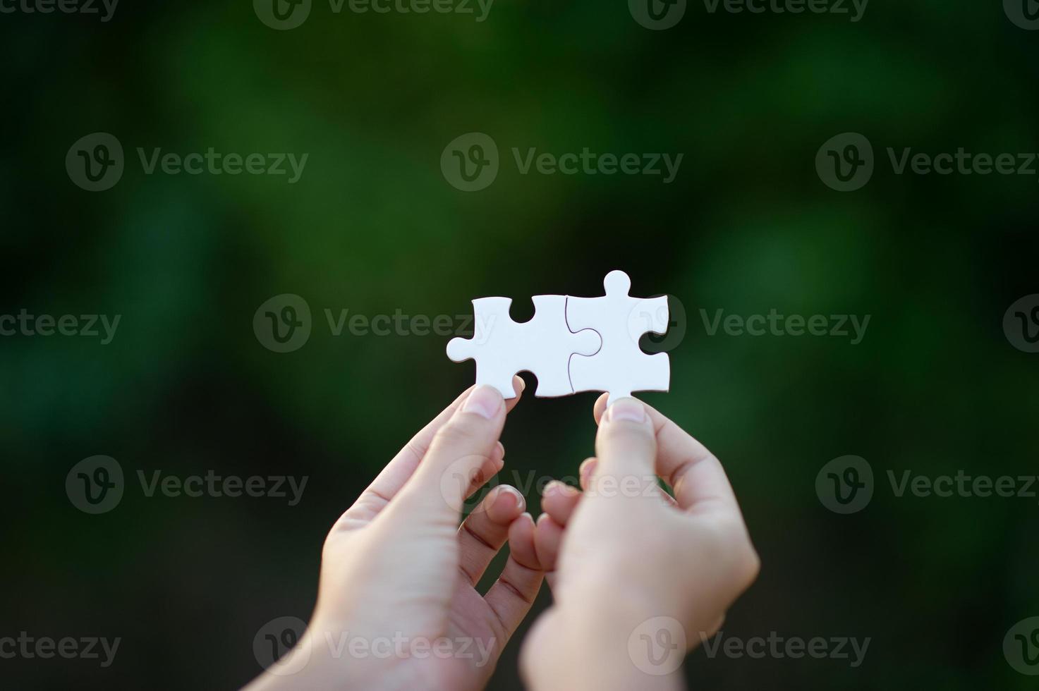 Hands and white jigsaw puzzles Close-up image and integration Business concept and unity photo