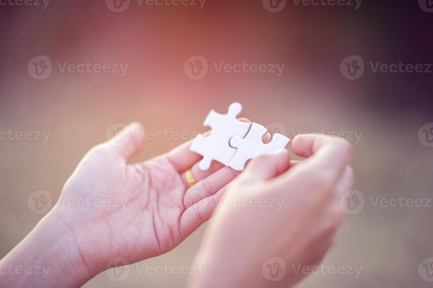 Hands and white jigsaw puzzles Close-up image and integration Business concept and unity photo