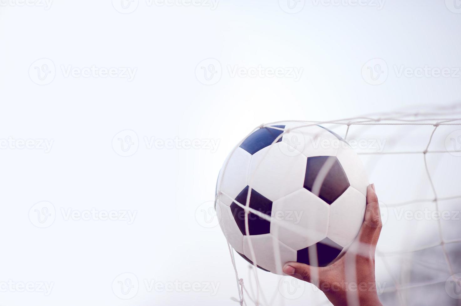 The cropped image of sports players who catch the ball and the football field. Sports-image concept. photo