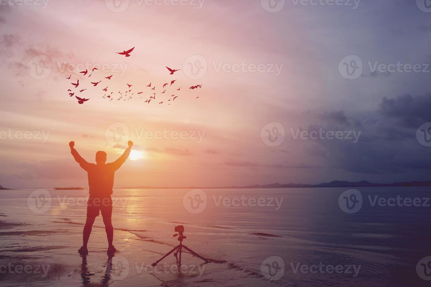 The photographer is happy by the sea and is happy with his photography. photo