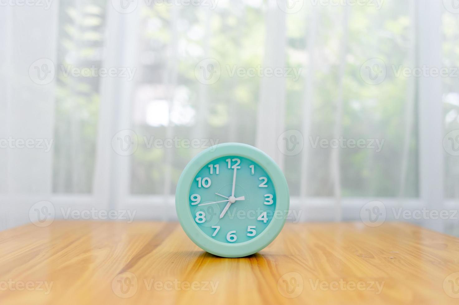 Light green alarm clock Placed on the table in the bedroom photo