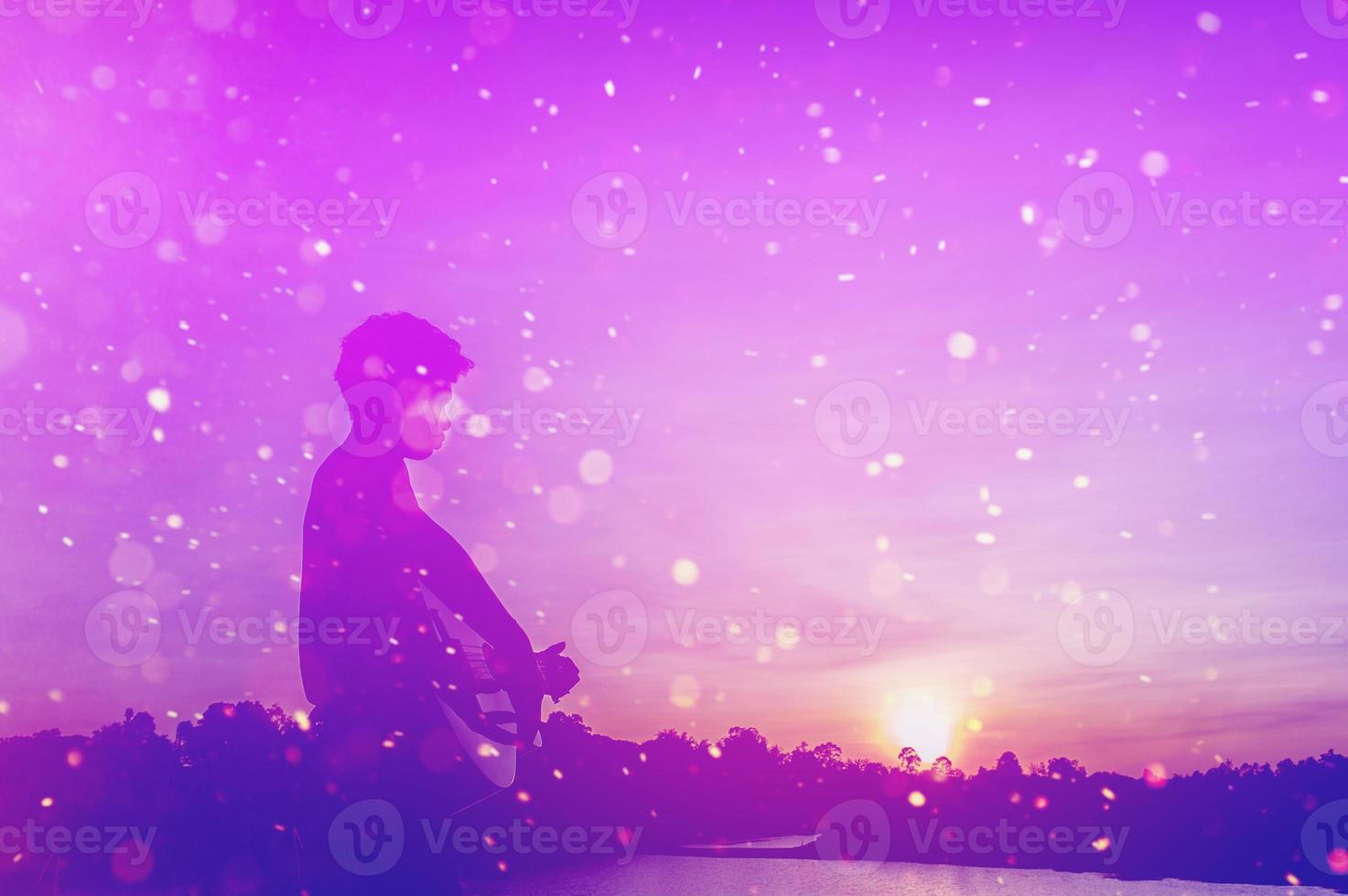 Silhouette of a guitarist in the shadows at sunset light, silhouette concept. photo