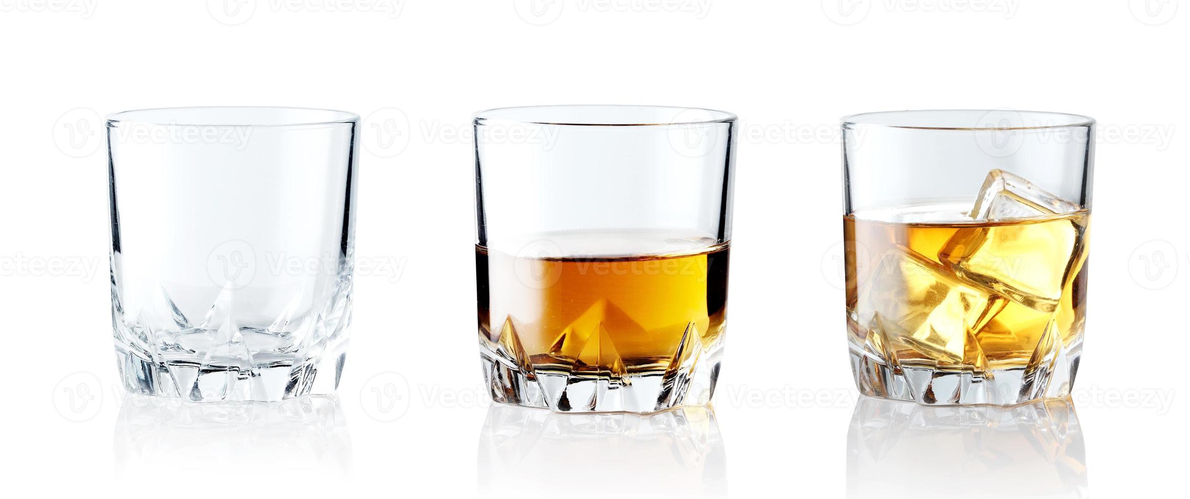 Set of alcoholic beverages. Scotch whiskey in elegant glass with ice cubes on white background. photo