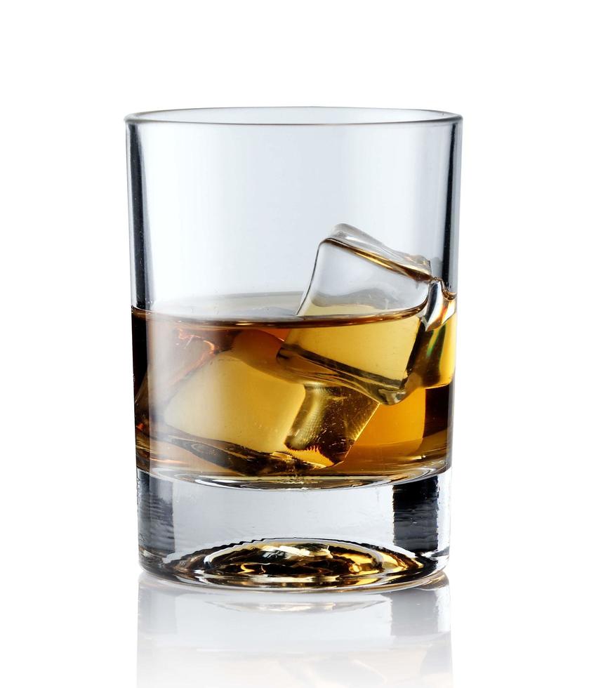 whisky escocés en un vaso elegante con cubitos de hielo sobre fondo blanco. foto