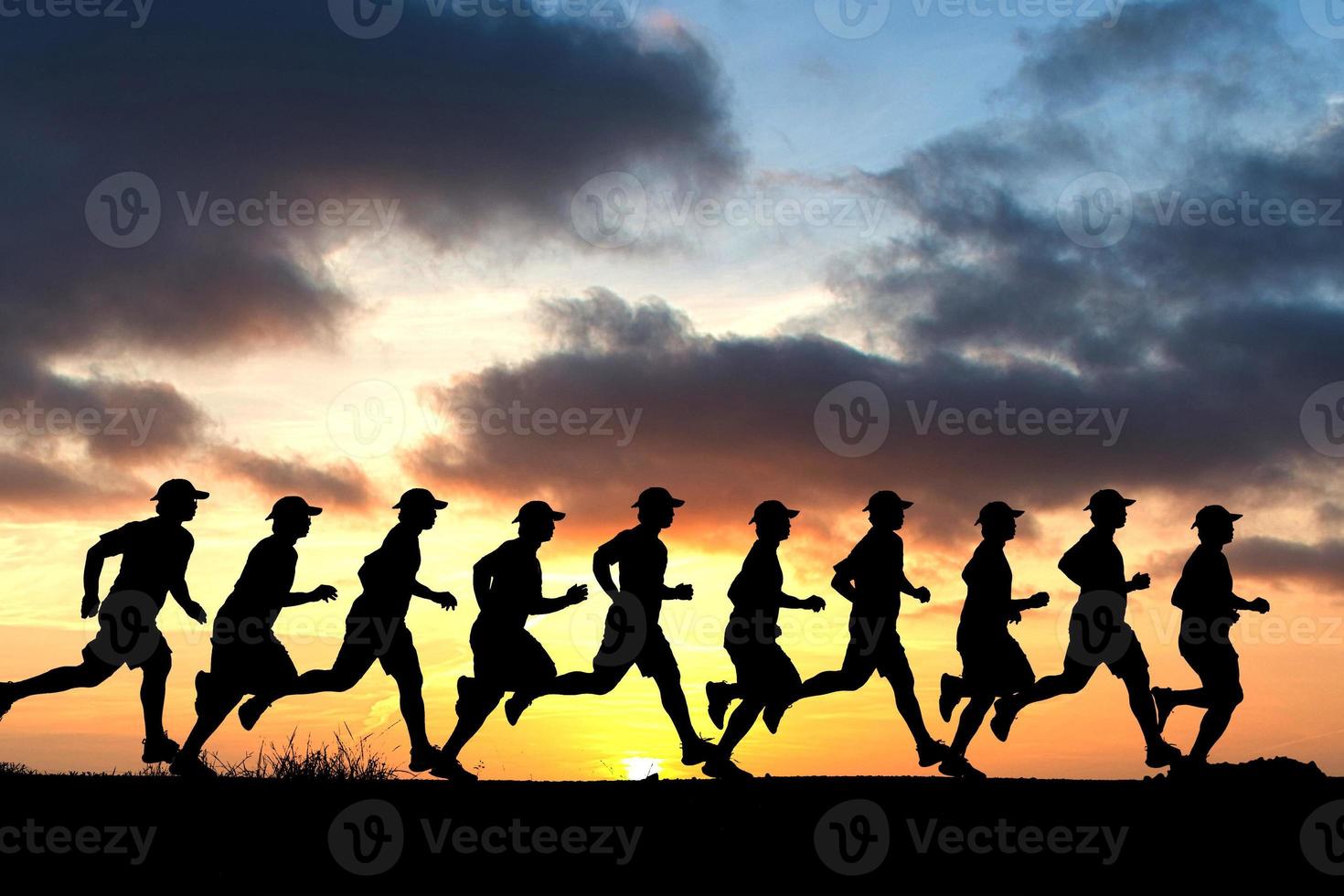 Running man silhouette in sunset time.  silhouette for a runner training in the evening. Sunsets photo