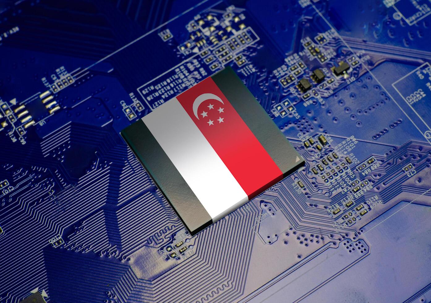The National Flag of Singapore on CPU operating chipset computer electronic circuit board photo