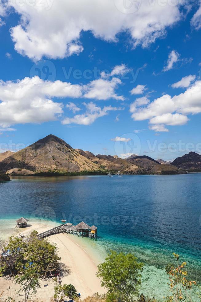 Exotic island and gazebo on the beach with seascape and hills photo