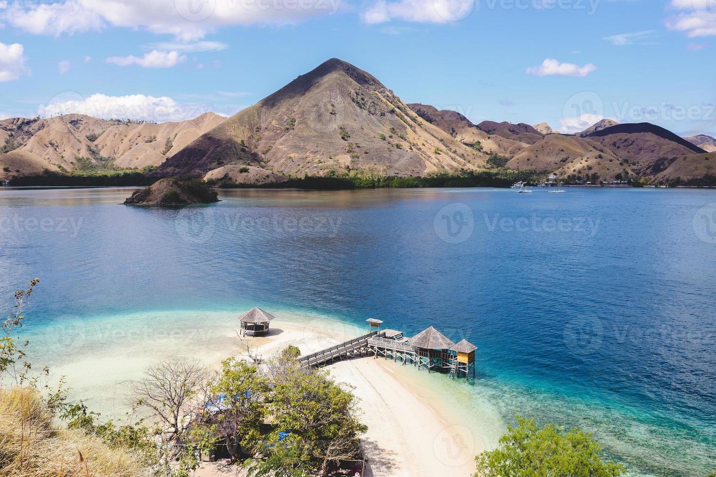 Exotic island and gazebo on the beach with seascape and hills photo