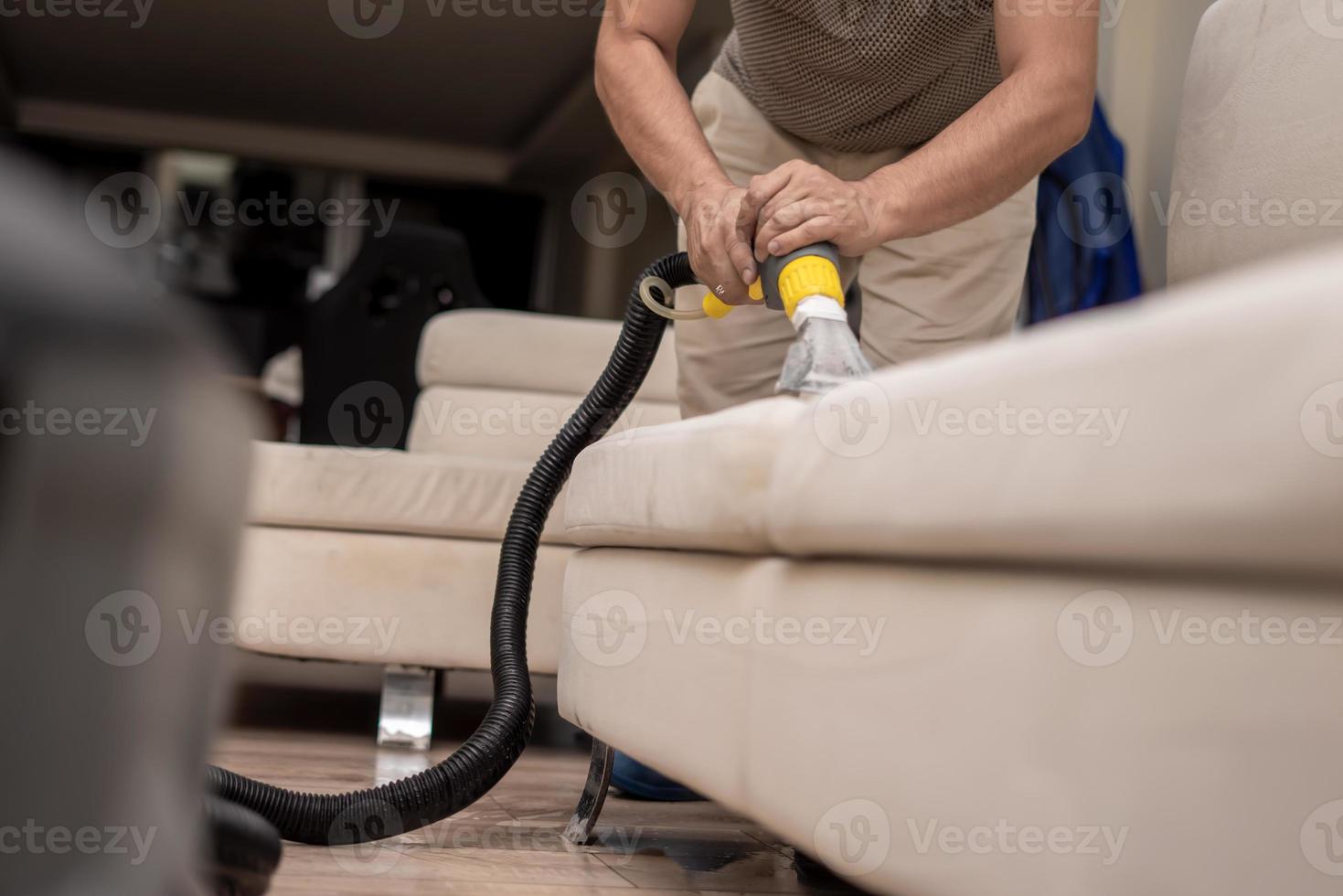 Cleaning a dirty sofa with a sofa washer photo