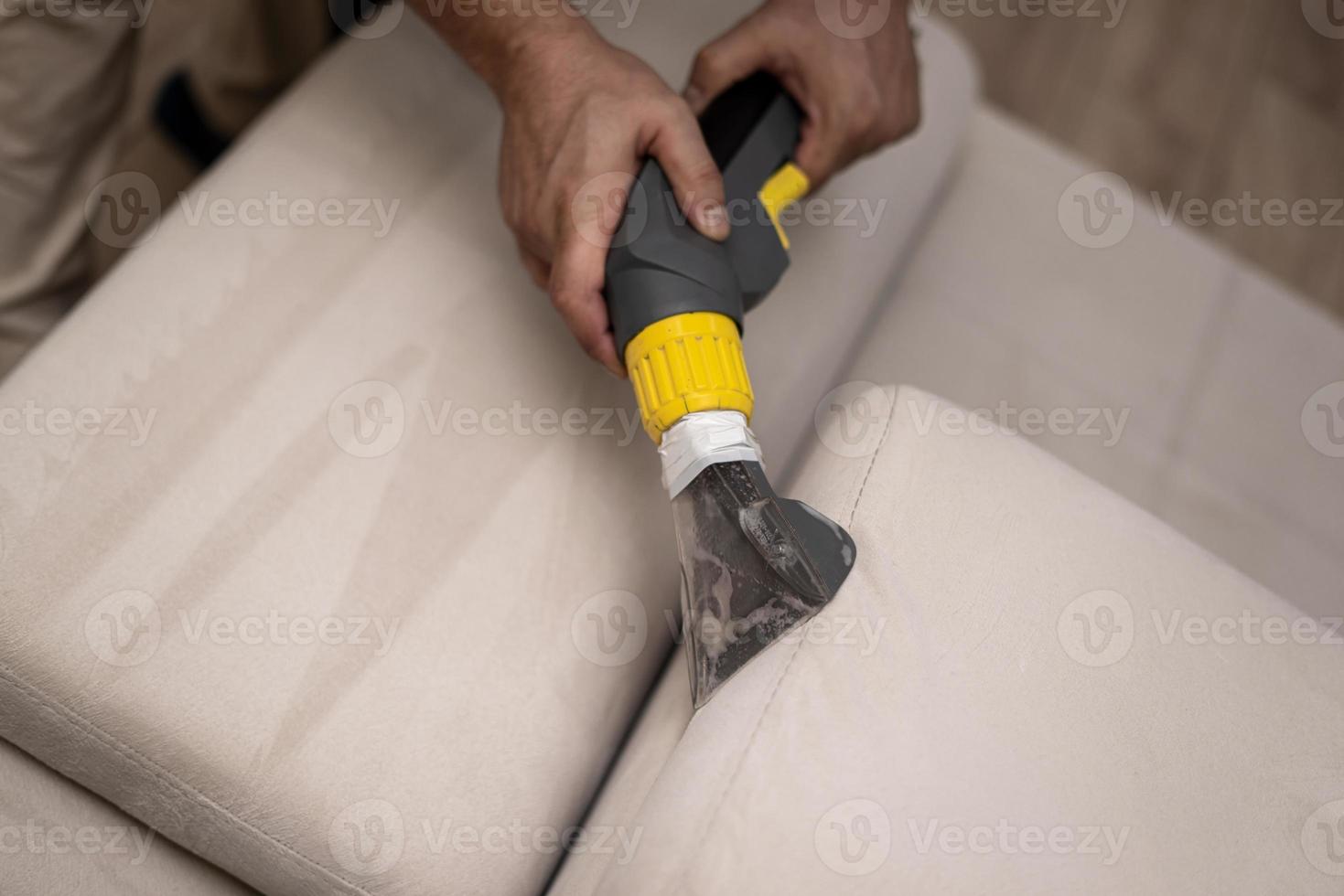 Cleaning a dirty sofa with a sofa washer photo