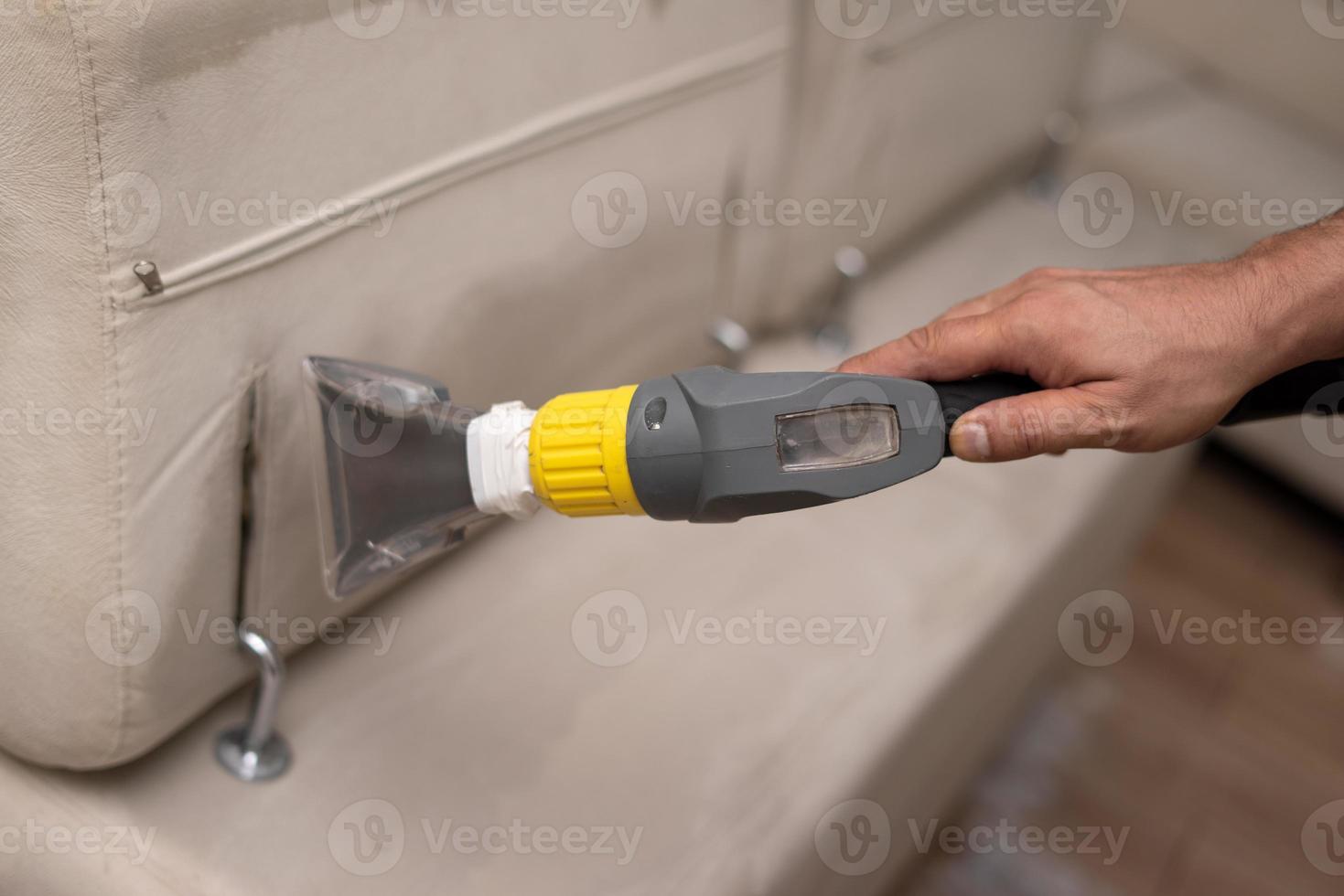 Cleaning a dirty sofa with a sofa washer photo